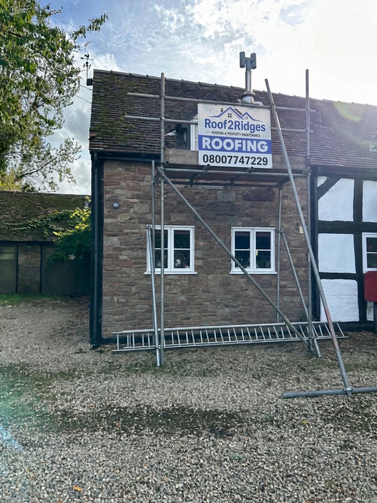 Roof 2 Ridges on site with branded scaffolding in Northampton
